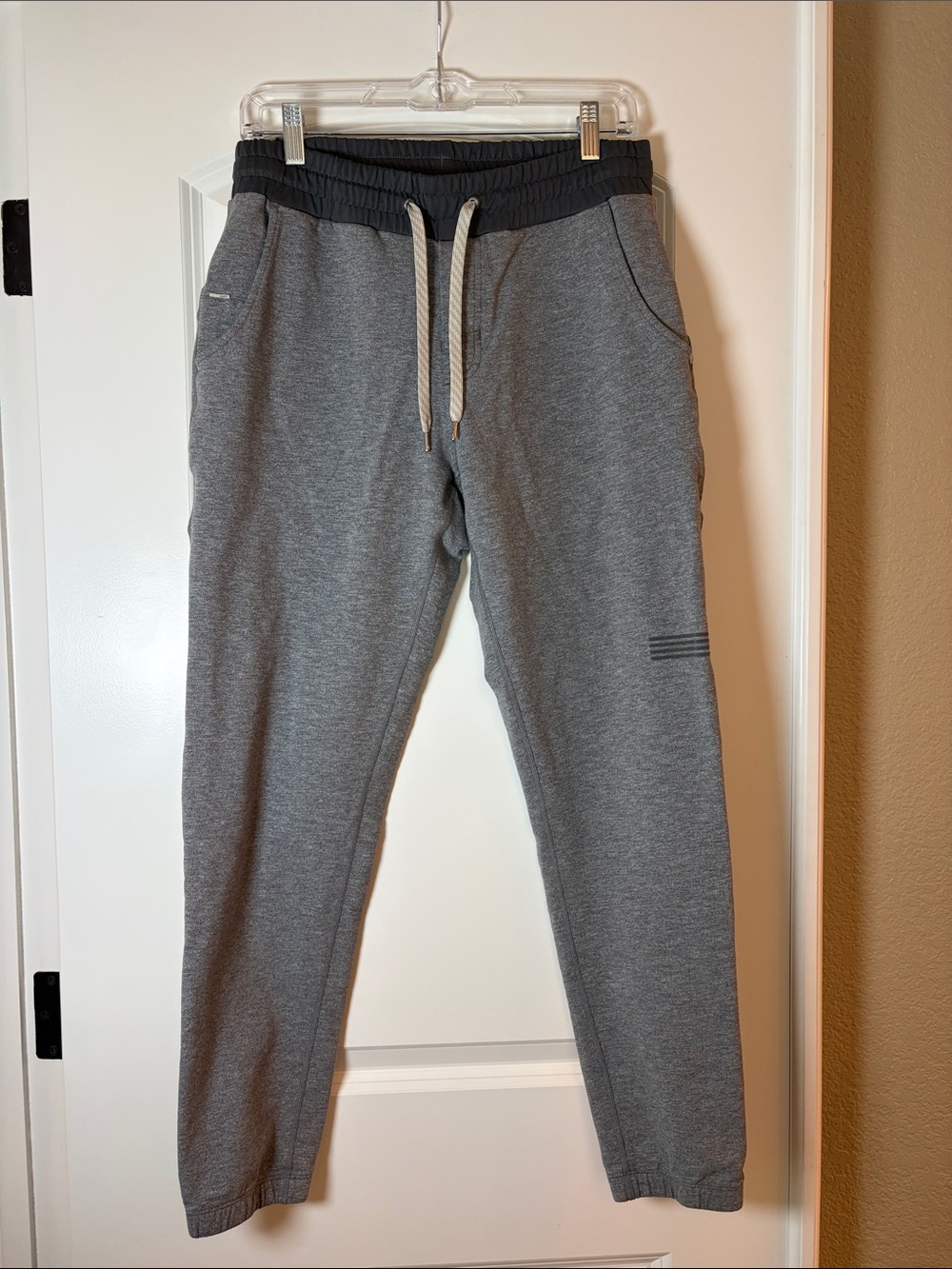Vuori Heather Gray Men’s Balboa Joggers with Dark Waistband and White Drawcord.